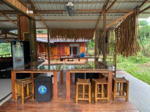 a dining area with a large table and some chairs at Cucu Suzanne in Lasikin