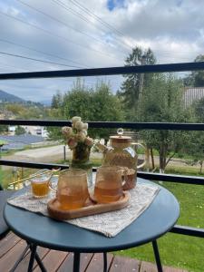 a table with two glasses and a vase on it at Center Cottage Чан in Slavske
