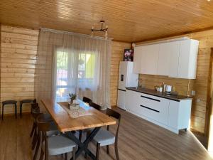 a kitchen and dining room with a table in a cabin at Center Cottage Чан in Slavske
