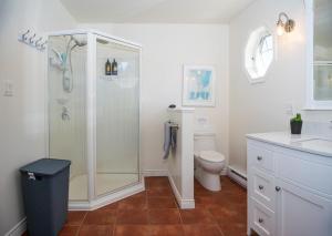 a bathroom with a shower and a toilet at Summer By The Sea Beach House in Saint Peters +39 photos