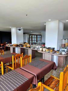 a restaurant with two tables and chairs and a kitchen at Stratus Centro Hotel in Volta Redonda +41 photos