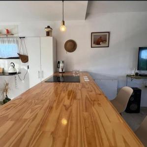 a kitchen with a large wooden table in a room at Nuestro Eden II Playa Dorada in Playa Dorada