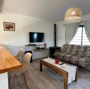 a living room with a couch and a table at Nuestro Eden II Playa Dorada in Playa Dorada