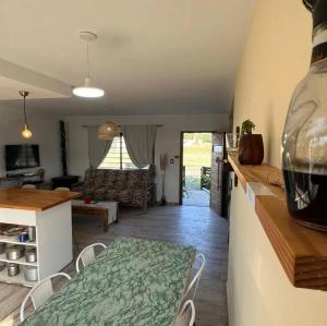 a kitchen and a living room with a table and chairs at Nuestro Eden II Playa Dorada in Playa Dorada +4 photos