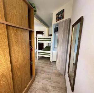 a hallway with wooden cabinets and a bed in a room at Nuestro Eden II Playa Dorada in Playa Dorada
