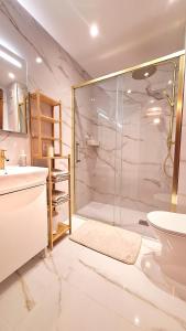 a bathroom with a shower and a toilet and a sink at Jona Candás Asturias in Candás +49 photos