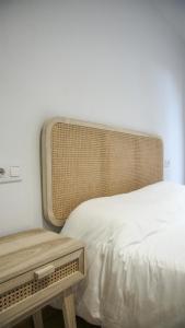 a bedroom with a bed and a bench next to it at Cal Perot Apartamento turístico en Les Borges Blanques in Les Borges Blanques 