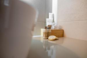 a bathroom with a counter with bottles ofodorizers and bread at No Pardon Hotel in Satu Mare +37 photos