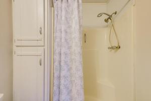 a white shower curtain next to a white door at Easy Hwy Access to ATL Work-Ready Riverdale Home in Riverdale +20 photos