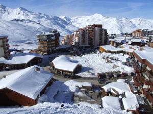 een stad bedekt met sneeuw met bergen op de achtergrond bij Peclet Appartements VTI in Val Thorens