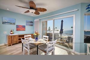a dining room with a table and a view of the ocean at 501P-12 Spectacular Ocean Views Pet Friendly in Oceanside