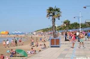 a group of people on the beach at the beach at La Vague in Gravelines