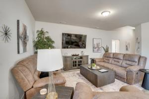 a living room with two couches and a table at Work, Explore and Unwind Lovely Permian Basin Home in Odessa