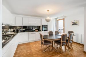 a kitchen with a dining room table and chairs at La Coupole in Évian-les-Bains