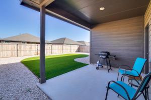 a screened in patio with chairs and a lawn at Work, Explore and Unwind Lovely Permian Basin Home in Odessa