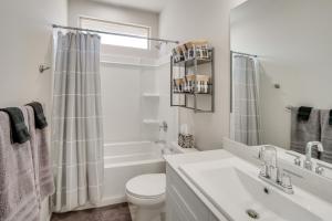 a white bathroom with a toilet and a sink at Work, Explore and Unwind Lovely Permian Basin Home in Odessa +20 photos