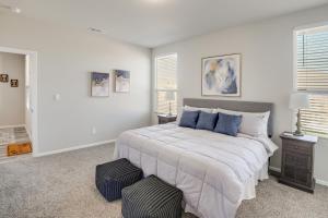 a bedroom with a large bed with blue pillows at Work, Explore and Unwind Lovely Permian Basin Home in Odessa