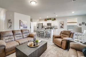 a living room with two couches and a kitchen at Work, Explore and Unwind Lovely Permian Basin Home in Odessa