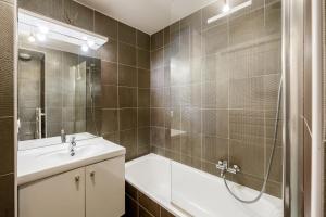 a bathroom with a tub and a sink and a shower at La Coupole in Évian-les-Bains +22 photos