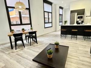 a large living room with a table and chairs at Apartamento Vive Zaragoza V in Zaragoza +17 photos
