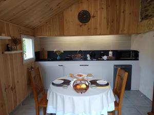 une cuisine avec une table avec un bol de fruits dessus dans l'établissement Le bel arbre, à Tressignaux