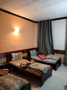 una persona acostada en una cama en una habitación en Hotel Mount Heaven, en Murree