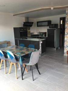 a kitchen with a table and chairs in a room at La Vague in Gravelines +7 photos