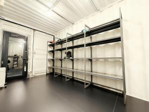a room with empty shelves in a room with a door at Lagom Hakuba in Hakuba