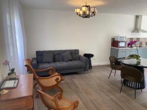 a living room with a couch and a table at Letoilevelli in Salazie +8 photos