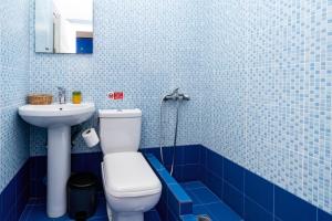a blue tiled bathroom with a toilet and a sink at Cyclades Beach in Platis Yialos Sifnos +62 photos