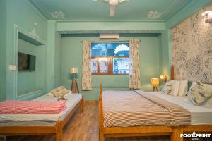 Ένα ή περισσότερα κρεβάτια σε δωμάτιο στο Footprint Hostel Udaipur