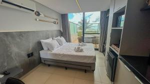 Ένα ή περισσότερα κρεβάτια σε δωμάτιο στο Flat Alta Garden pé na areia, Praia do Bessa