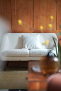 a white couch in a room with a table at Charming Historical Apartment in Zurich City Center Oldtown in Zurich