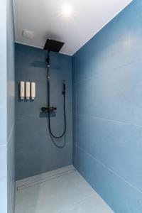 ein Badezimmer mit einer Dusche mit blauer Wand in der Unterkunft Luxury Top Floor Sea View Downtown Cap d'Ail in Cap d'Ail