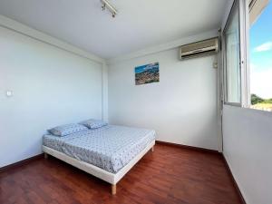 Ένα ή περισσότερα κρεβάτια σε δωμάτιο στο Le Sunset