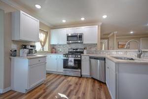 a kitchen with white cabinets and a stove top oven at Three Oaks in Mena