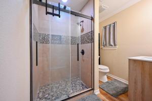 a bathroom with a glass shower with a toilet at Three Oaks in Mena +7 photos