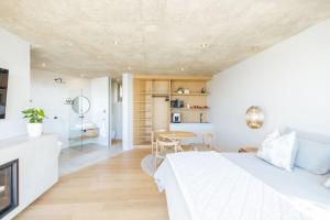 a bedroom with a white bed and a table at RRoar George in Herolds Bay +123 photos