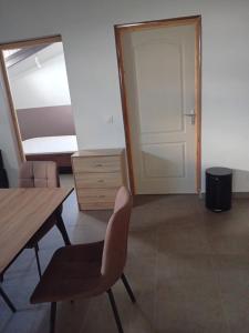 a room with a desk and a chair and a mirror at sci careffour dugomier in Le Moule +3 photos