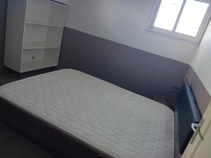 a bed in a bedroom with a window at sci careffour dugomier in Le Moule