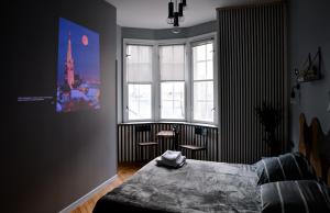 a bedroom with a bed and a large window at Bolero Apart in Tallinn