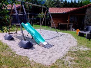 a playground with a slide in a yard at LE HAMEAU du COMTE de FOIX in Mercus-Garrabet
