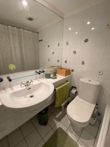 a bathroom with a white toilet and a sink at San Alfonso del Mar, Vela Mayor in Algarrobo +16 photos