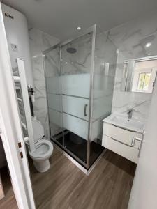 a bathroom with a shower and a toilet and a sink at Studio neuf à Crosne in Crosne