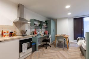 a kitchen with a desk and a table in a room at For Students Only The Brook in Bath in Bath
