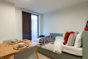 a bedroom with a bed and a dining table at For Students Only The Brook in Bath in Bath