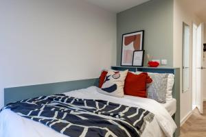 a bedroom with a bed with a blue headboard at For Students Only The Brook in Bath in Bath +2 photos