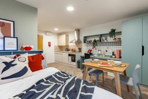 a room with a bed and a table and a kitchen at For Students Only The Brook in Bath in Bath
