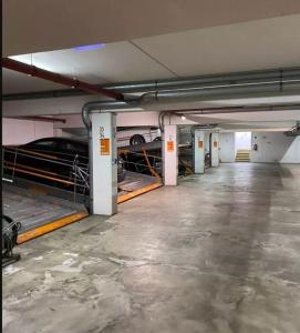 an empty parking garage with cars parked in it at Family & Business Apartment Erlangen, Siemens & Uni Nähe in Erlangen