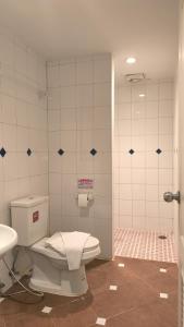 a bathroom with a toilet and a sink at Bursa Hotel Patong in Patong Beach